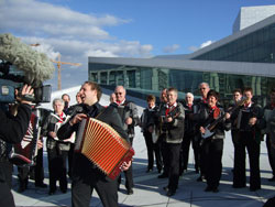 Thomas Stanghelle (in front) and Lindesnes Trekkspillklubb performing from Stanghelles new Accordion Opera in front of the new Opera House in Bj&oslash;rvika, Oslo.